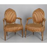 A pair of beech and upholstered fauteuils