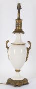 Lighting to include a converted late 19th century white bodied gilt metal mounted table lamp
