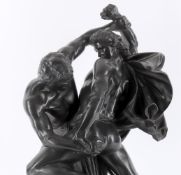 An early 20th century Danish black glazed basalt figural group of two warriors in combat