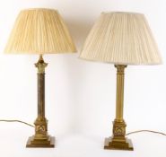 A pair of brass columnar lamps and shades