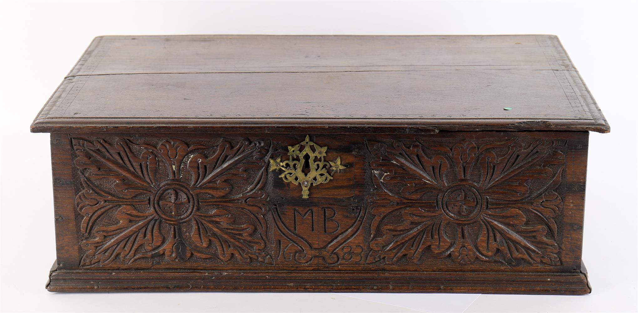 A 17th century and later oak box with carved decoration