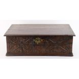 A 17th century and later oak box with carved decoration