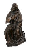 A German carved wood model of a kneeling monastic Saint