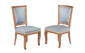 A pair of mahogany, parcel gilt and upholstered side chairs, in Empire style