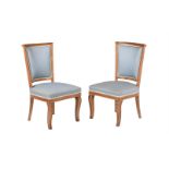 A pair of mahogany, parcel gilt and upholstered side chairs, in Empire style