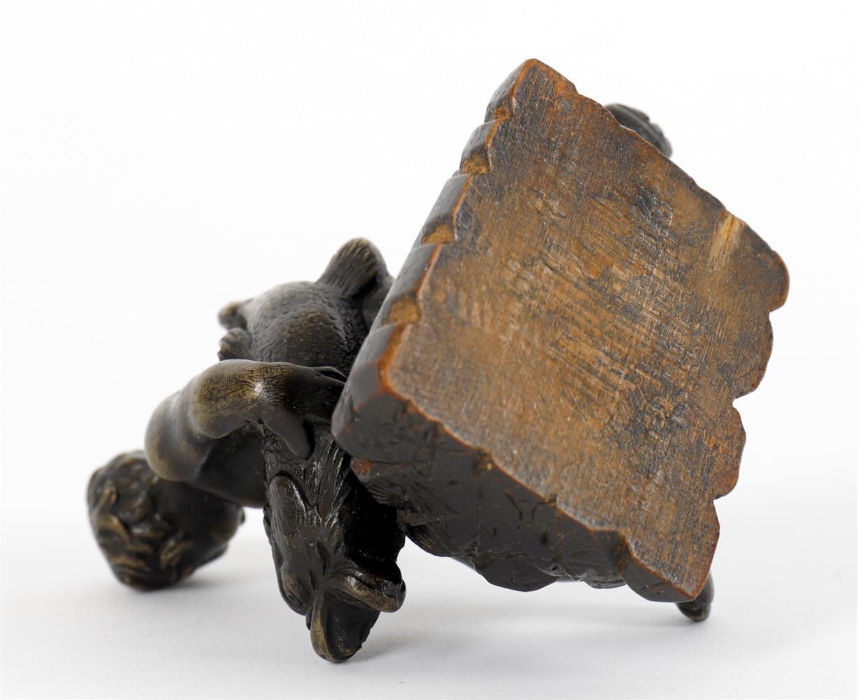 A small bronze of a seated child wrestling a dolphin and a bronze figural seal - Image 3 of 11