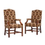 A pair of mahogany and tapestry upholstered open armchairs in George III style