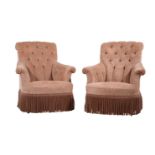 A pair of pink upholstered armchairs in late 19th century style
