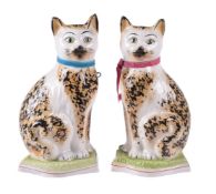 A pair of Staffordshire pottery models of cats of William Kent Ltd.