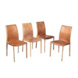A set of four faux leather clad dining chairs