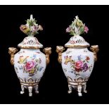 A pair of Meissen pot pourri urns and pierced covers