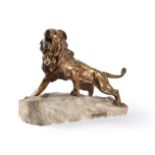 A bronze model of a lion on a stone base