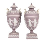 A pair of Wedgwood lilac-dip Jasper two handled urns and covers