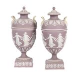 A pair of Wedgwood lilac-dip Jasper two handled urns and covers