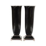 A pair of floor standing black lacquered and silver painted wooden vases