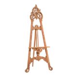 A carved and stripped softwood easel in Rococo taste