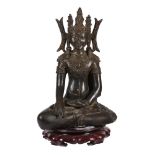 A bronze figure of the crowned Buddha