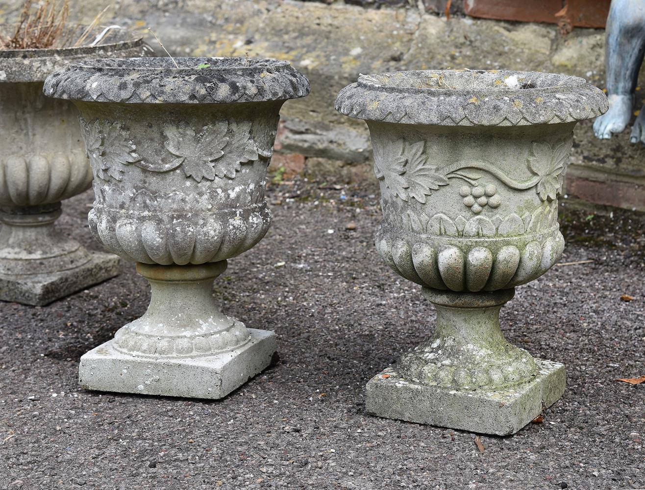 A pair of composition stone urns