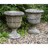 A pair of composition stone garden urns