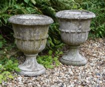 A pair of composition stone garden urns