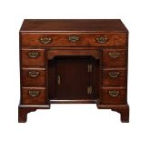 A George II 'red walnut' kneehole desk