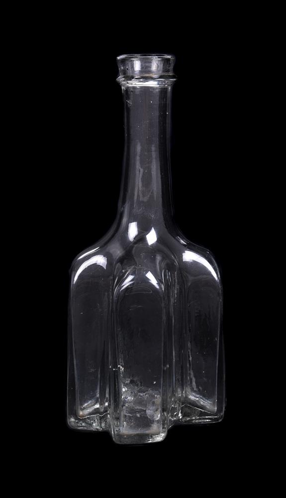 An English cruciform clear-glass decanter or serving bottle