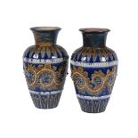 A pair of Doulton Lambeth stoneware shouldered ovoid vases by George Tinworth