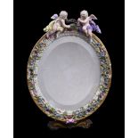 A Meissen flower encrusted and gilt metal mounted oval strut looking glass