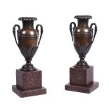 A pair of bronzed metal urns in Empire style