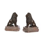 A pair of bronze models of seated lions