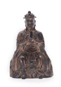 A Chinese gilt bronze and red lacquer Daoist figure of an Immortal