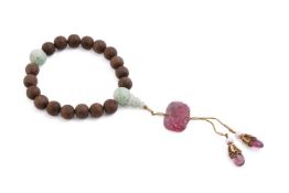 A Chinese aloeswood and jadeite rosary bracelet