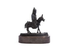 A Chinese bronze of a Daoist figure on a mule