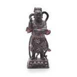A Chinese lacquer and mother of pearl inlaid figure of a Deity