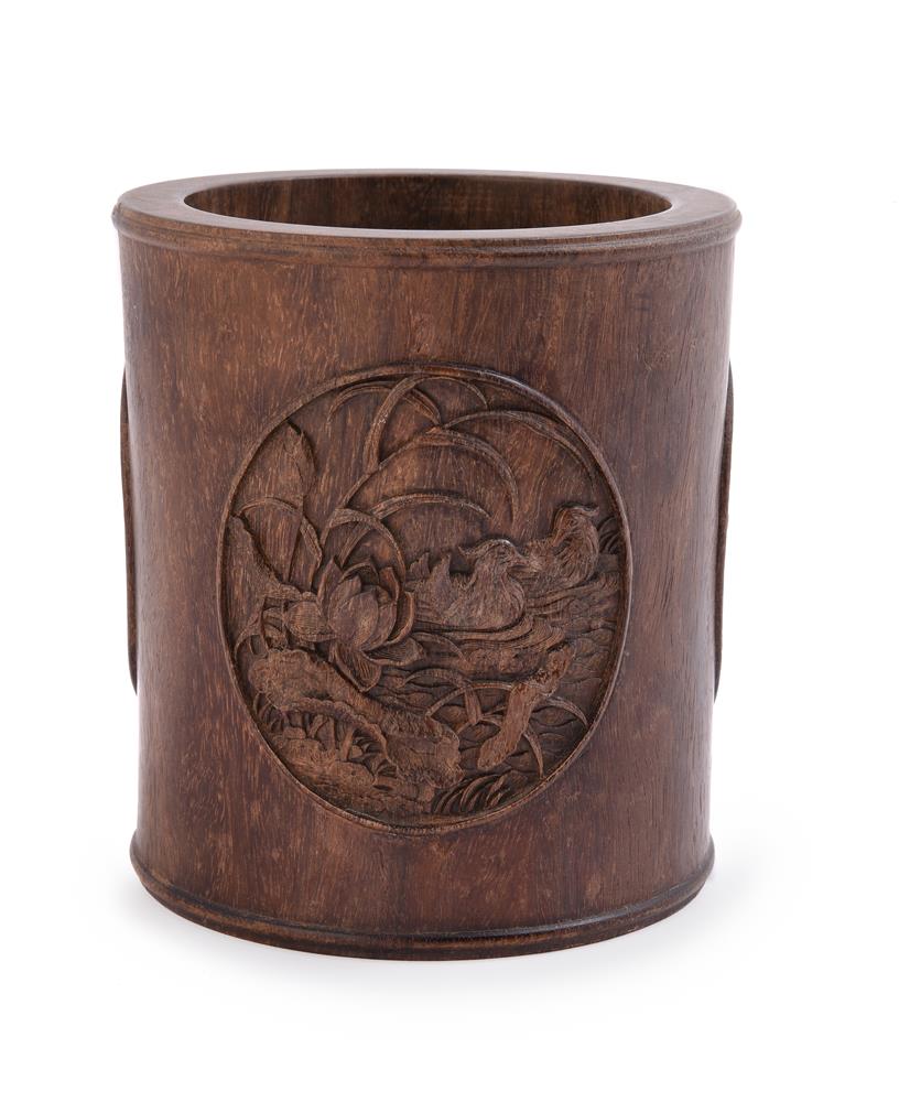 A carved hardwood brush pot