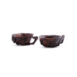 A pair of Chinese Huanghuali 'prunus and lotus' cups