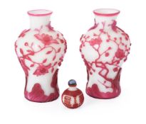 A pair of Chinese pink overlay white Peking glass 'Bird and Prunus Tree' vases