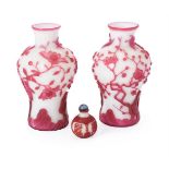 A pair of Chinese pink overlay white Peking glass 'Bird and Prunus Tree' vases