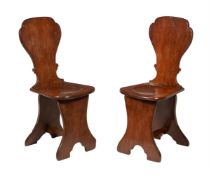 A pair of George II oak sgabello hall chairs