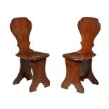 A pair of George II oak sgabello hall chairs