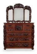 A Japanese carved exotic hardwood cabinet with tryptic mirrored top
