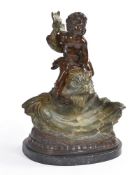 After Sylvain Kinsburger (French 1855 - 1935) A bronzed model of a Putto astride a dolphin