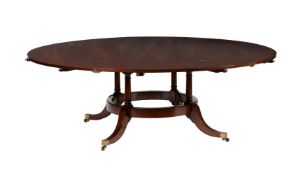 A mahogany extending circular dining table