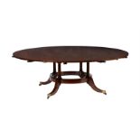 A mahogany extending circular dining table