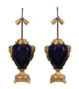 A pair of blue porcelain and gilt metal mounted table lamps