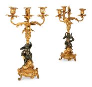 A pair of French gilt and patinated bronze candelabra
