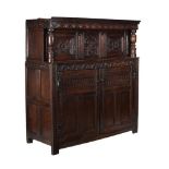 A Charles II carved oak court cupboard