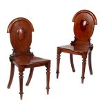 A pair of Victorian mahogany hall chairs