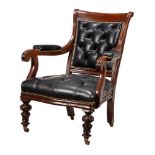 A Victorian mahogany and black leather upholstered library armchair