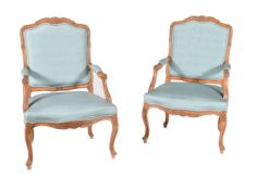 A pair of carved beech and blue upholstered fauteuil in Louis XV style